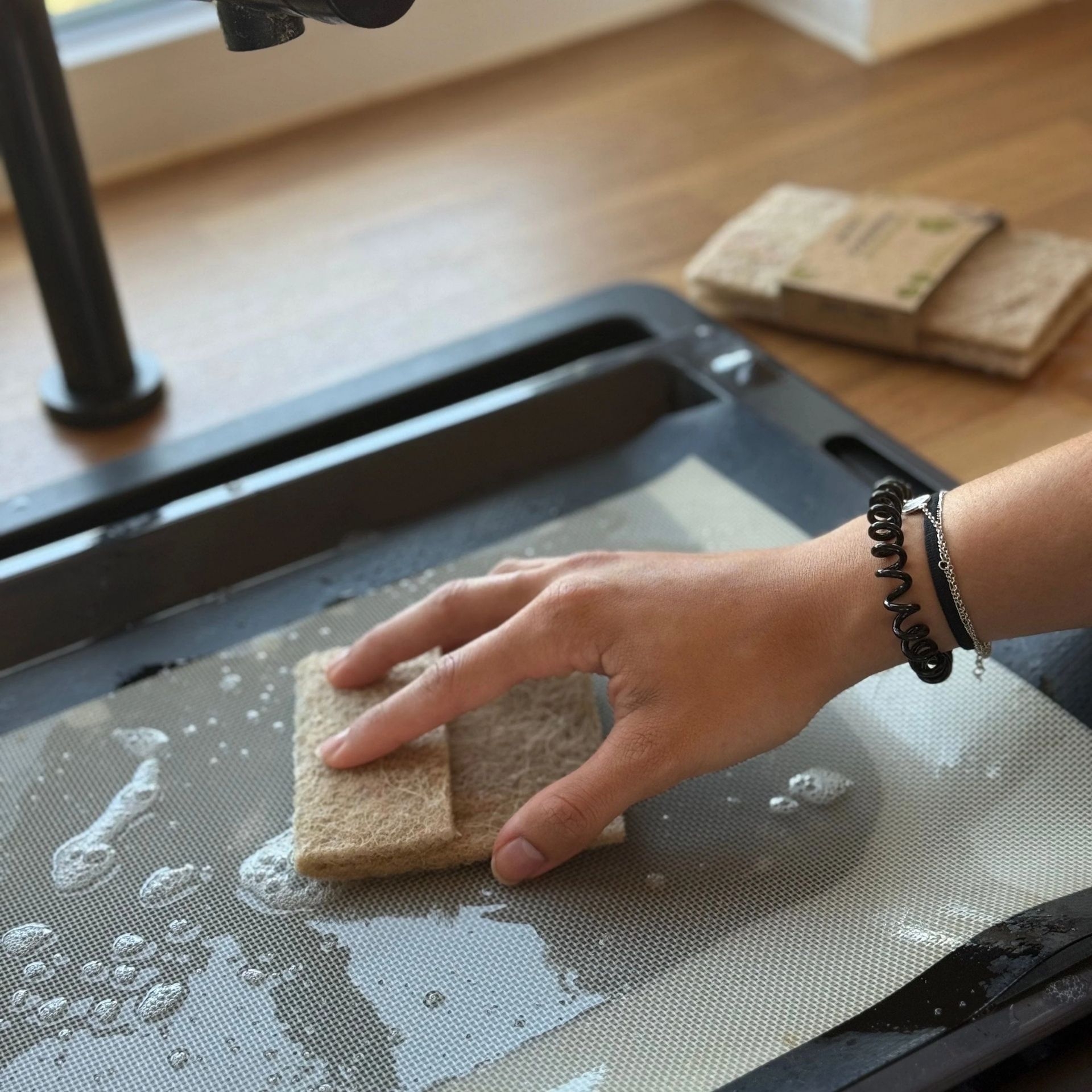 pandoo Sisal-Scheuerpad beim Reinigen einer Flaeche mit Wasser und Schaum
