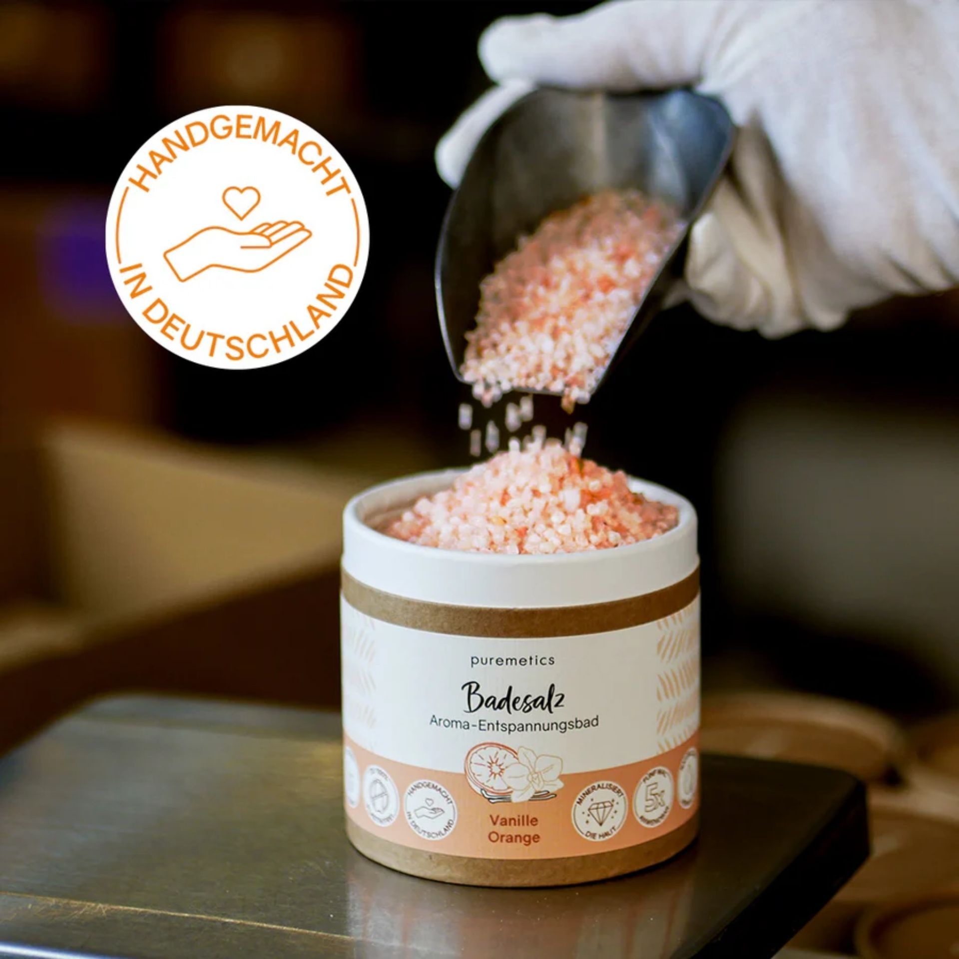 Handgemachtes Badesalz Vanille Orange wird mit Schaufel in einen Behaelter gefuellt