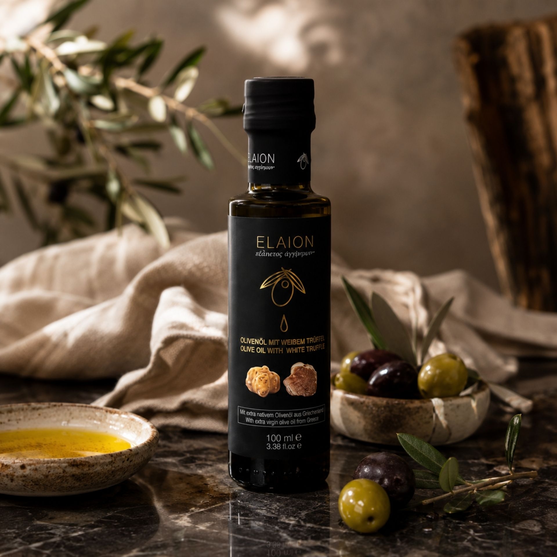 Elaion Olivenoel mit weissem Trueffel 100 ml in mediterranem Premium-Stilllife mit Oliven