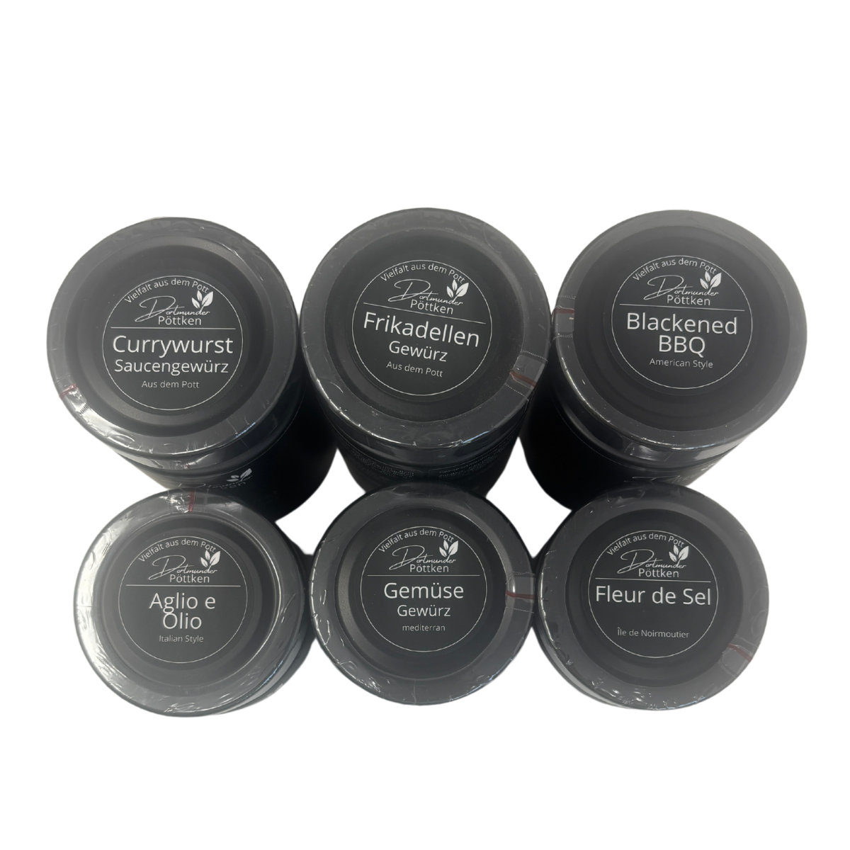 Sechs schwarze Gewuerzglaeser von oben fotografiert in schwarzer Box